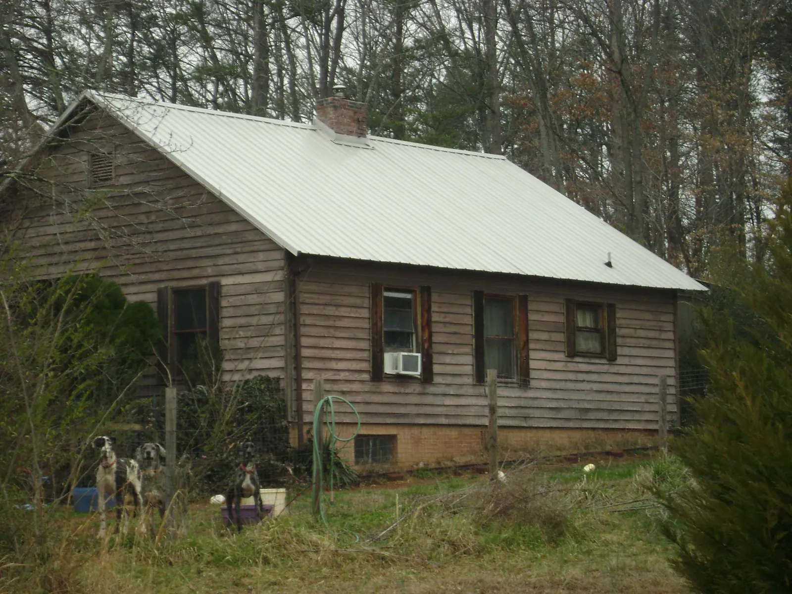 White metal roof on an old wood sided farmhouse, from a Metal Roof Installation job in Terre Haute