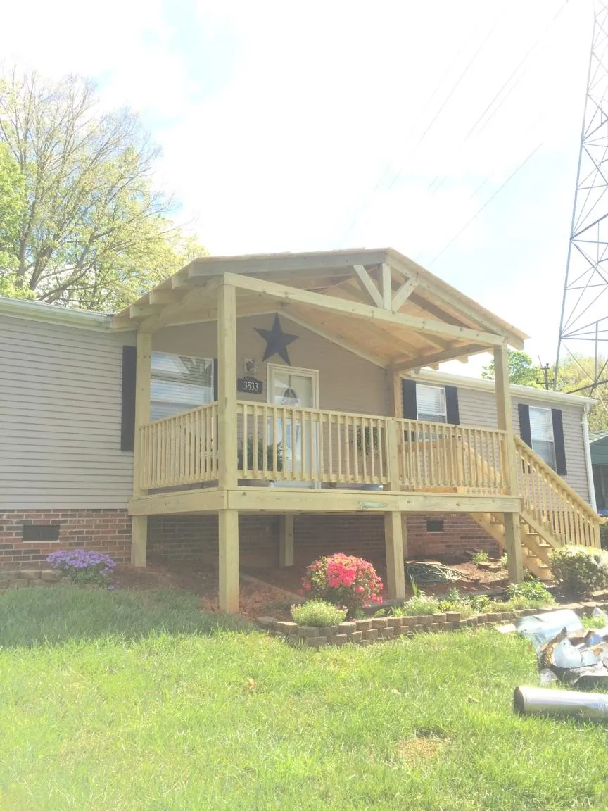 New gabled porch roof and deck railing added to a ranch home in Terre Haute